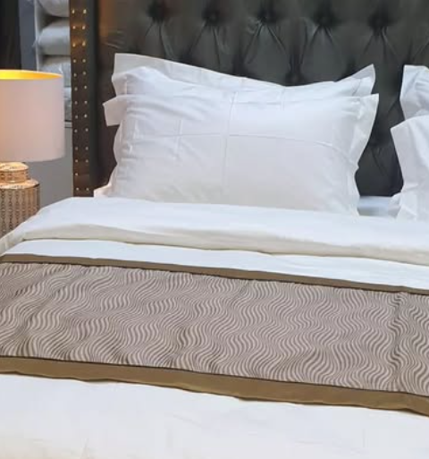 What’s the Purpose of the Fabric Strip Across Hotel Beds?