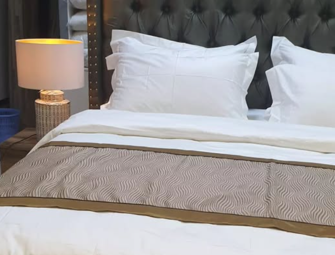 What’s the Purpose of the Fabric Strip Across Hotel Beds?